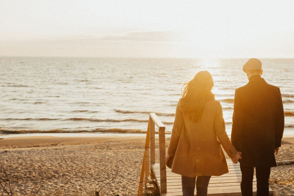 Couple holding hands on the beach