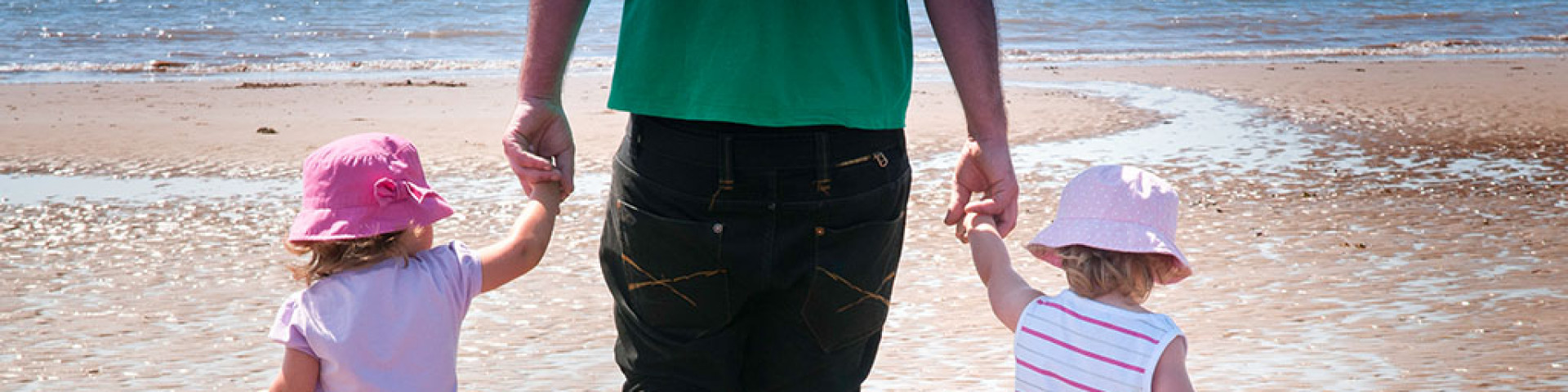 Children on beach with father at Aberdovey