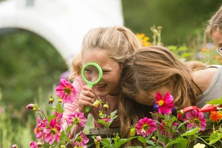 Girls playing with magnifying glass